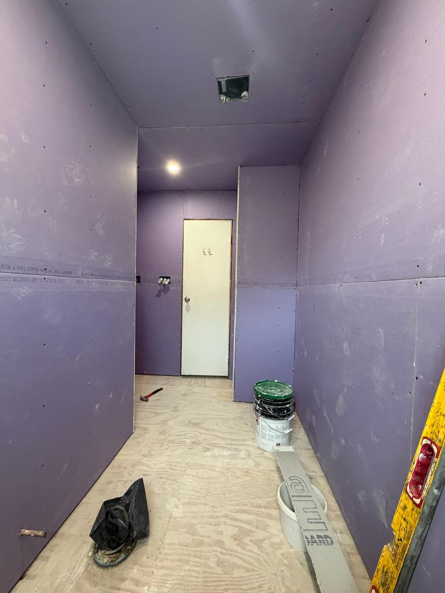 Moisture-resistant purple drywall and plywood subfloor