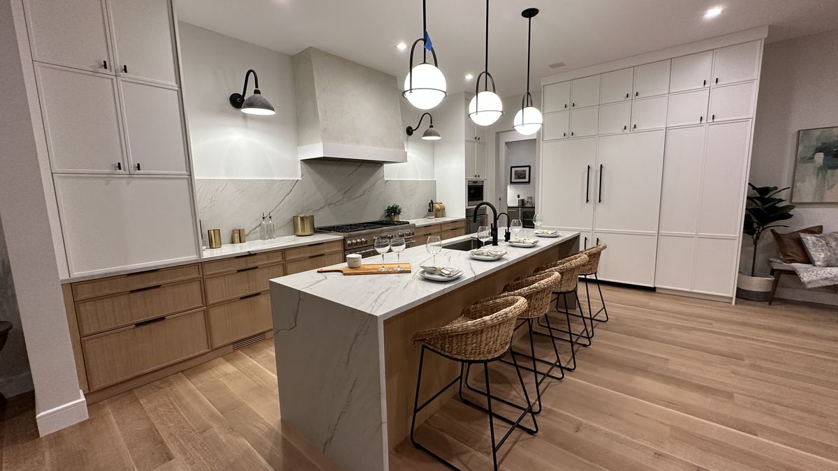 Quartz kitchen countertop with waterfall edge and white cabinetry
