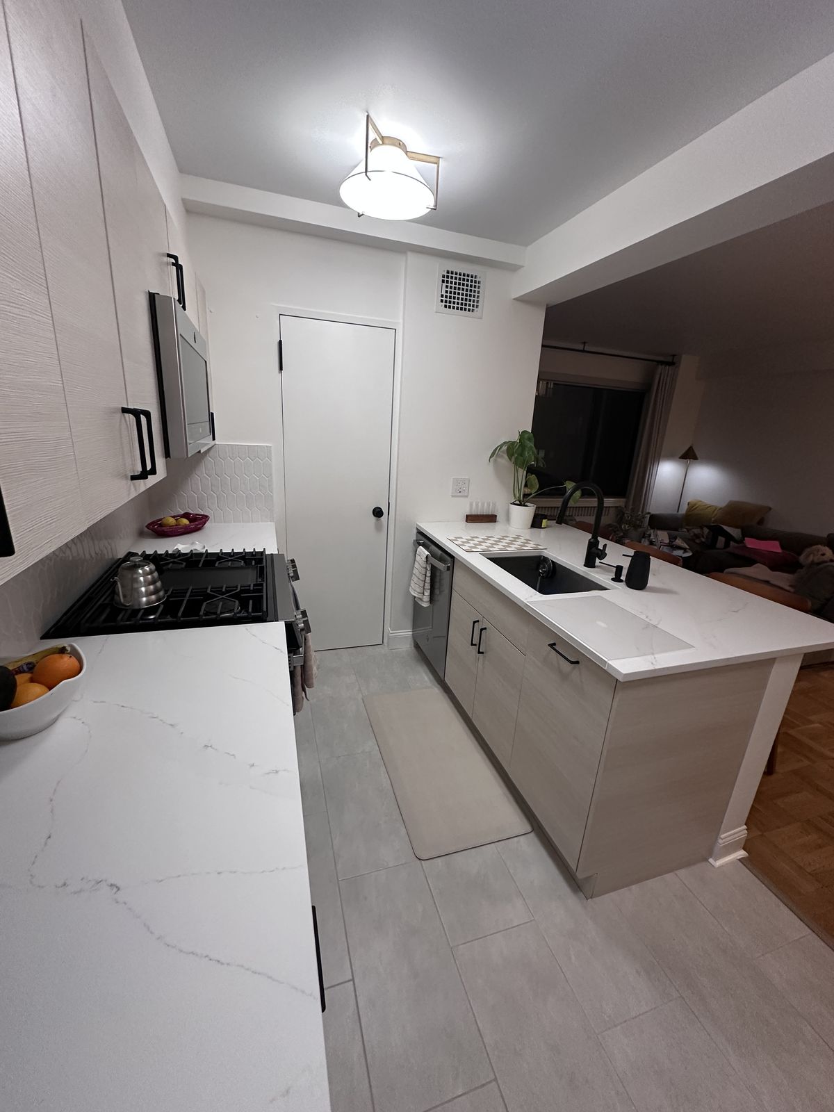 Kitchen island with calacatta quartz countertop and overhang for seating
