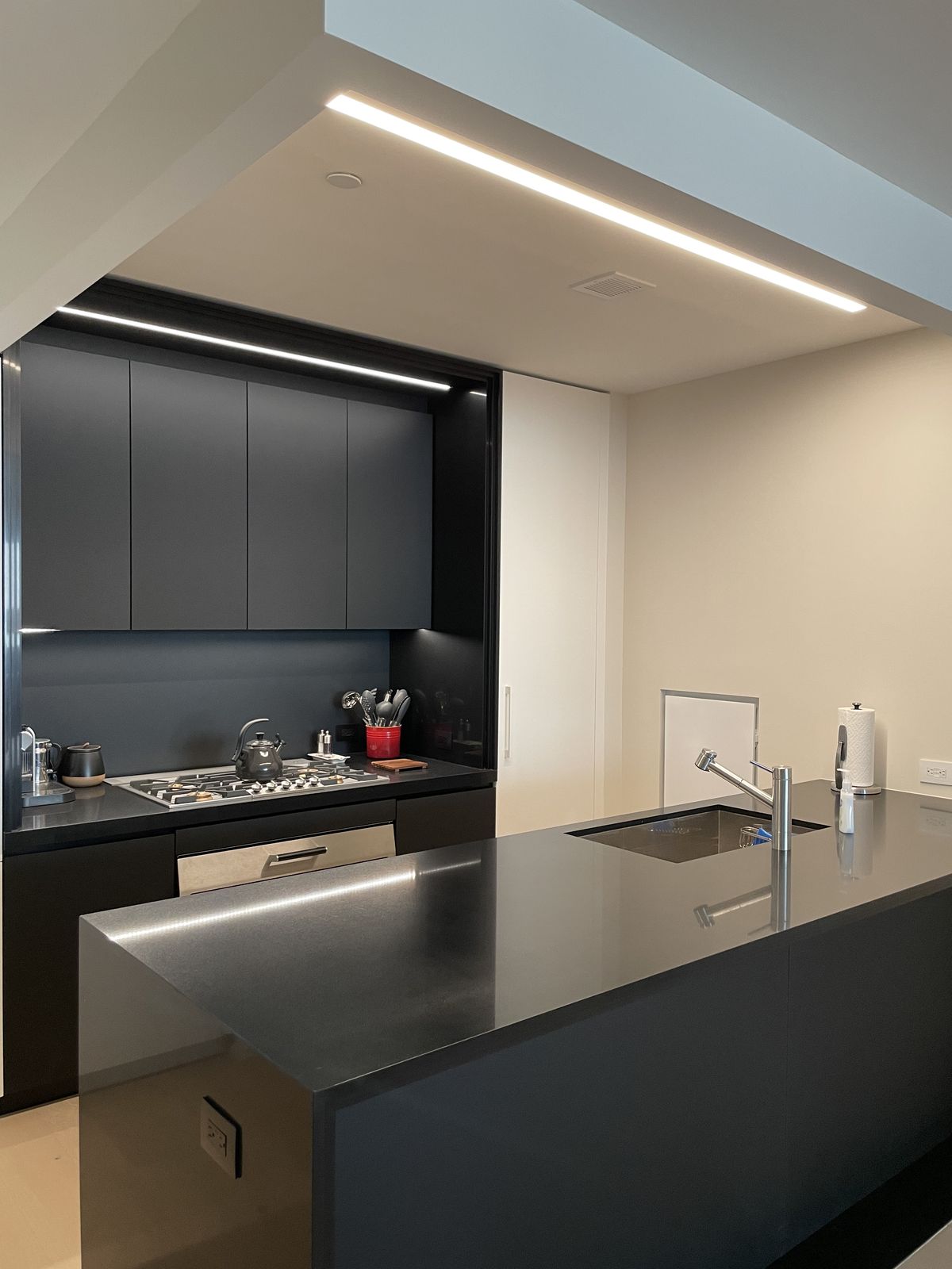 Finished kitchen with stone countertops and modern cabinetry