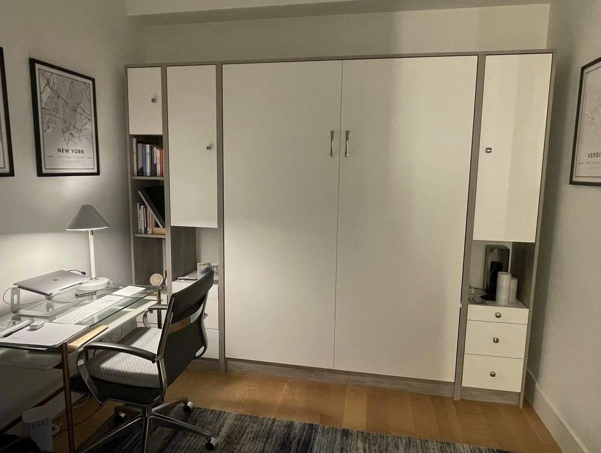 Custom Murphy bed with integrated office desk in space-efficient NYC apartment design