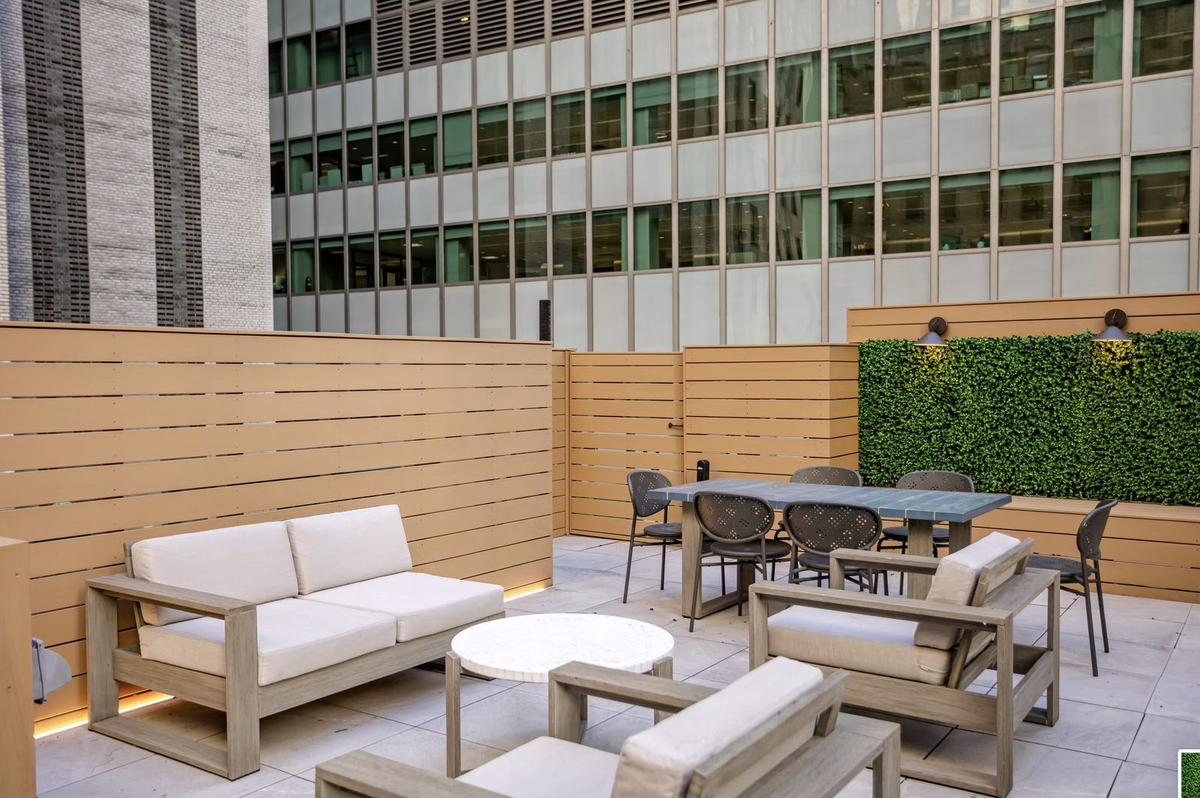 Rooftop terrace lounge area with custom seating and city views in NYC
