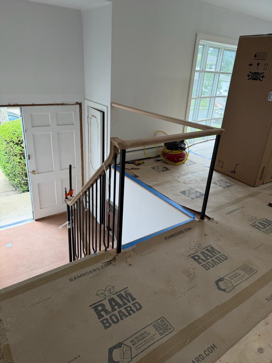 Iron baluster and oak handrail installation in progress