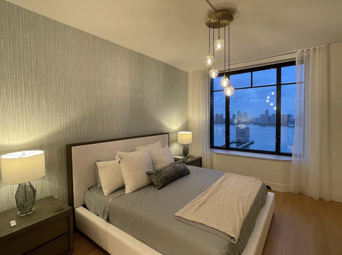 Bedroom with custom closets and refinished floors in Hudson Square NYC apartment