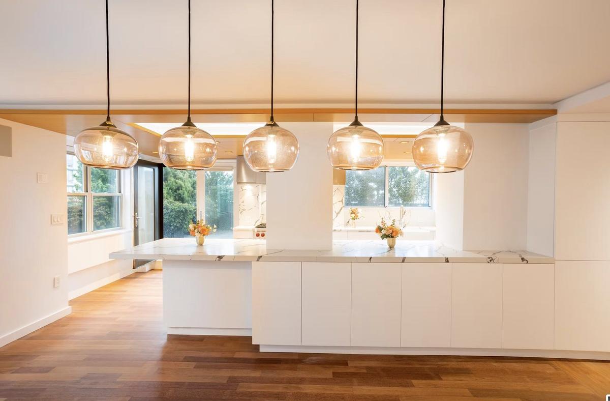 Kitchen detail showing backsplash tile work and under-cabinet lighting in NYC apartment